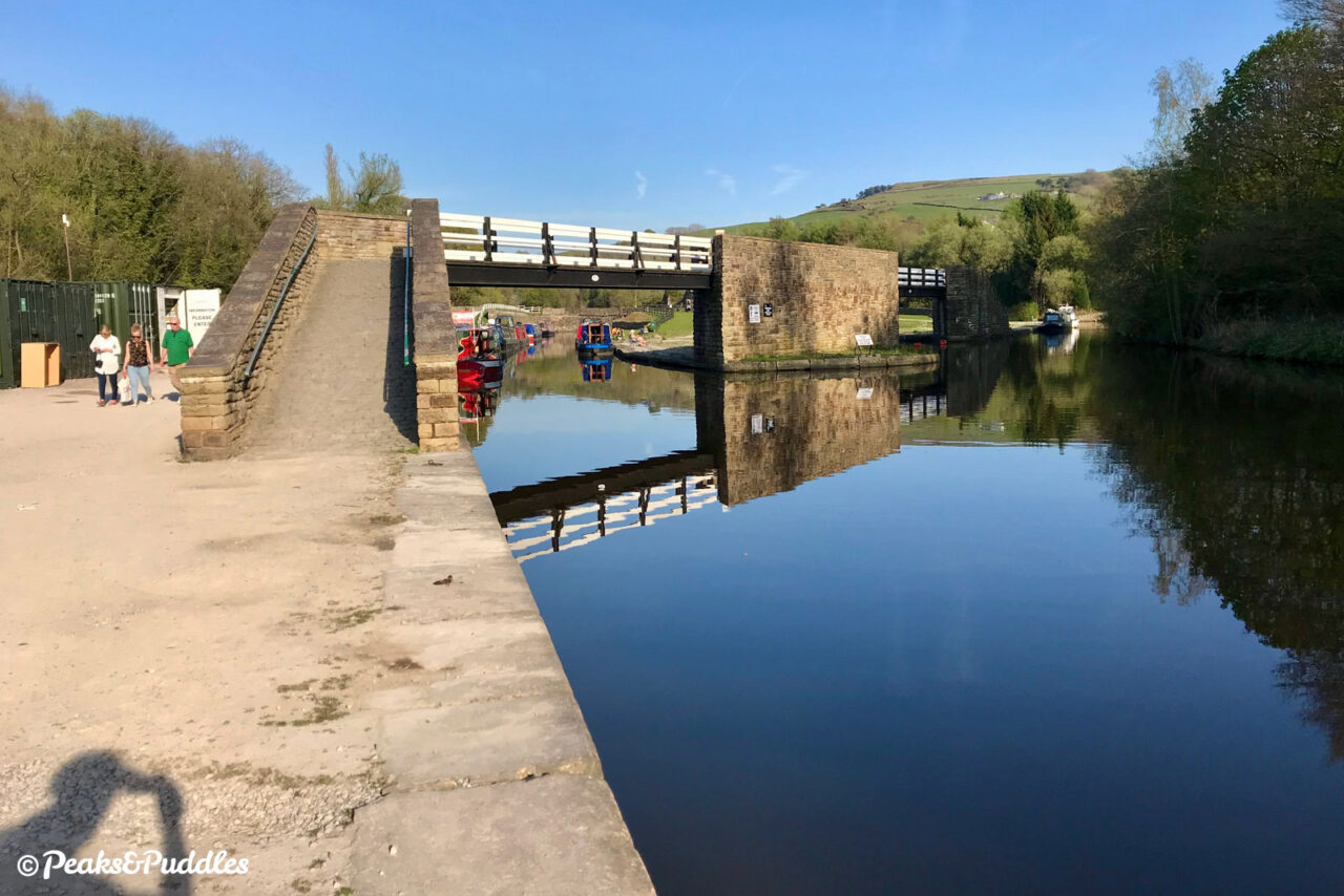 Bugsworth Basin is now a beautiful expanse of water following painstaking restoration. The crossover bridge between the wharfs is a recreation of the original.