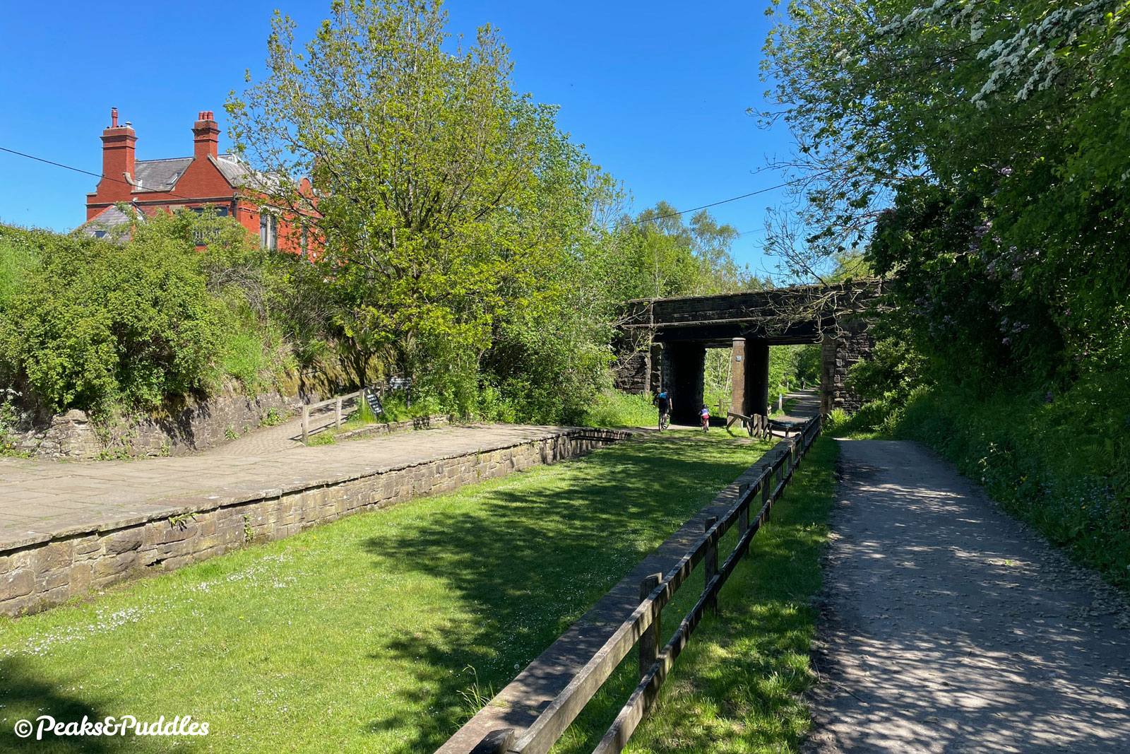 The former Higher Poynton station has a picnic spot between the old platforms and a cafe and pub up alongside the road above.